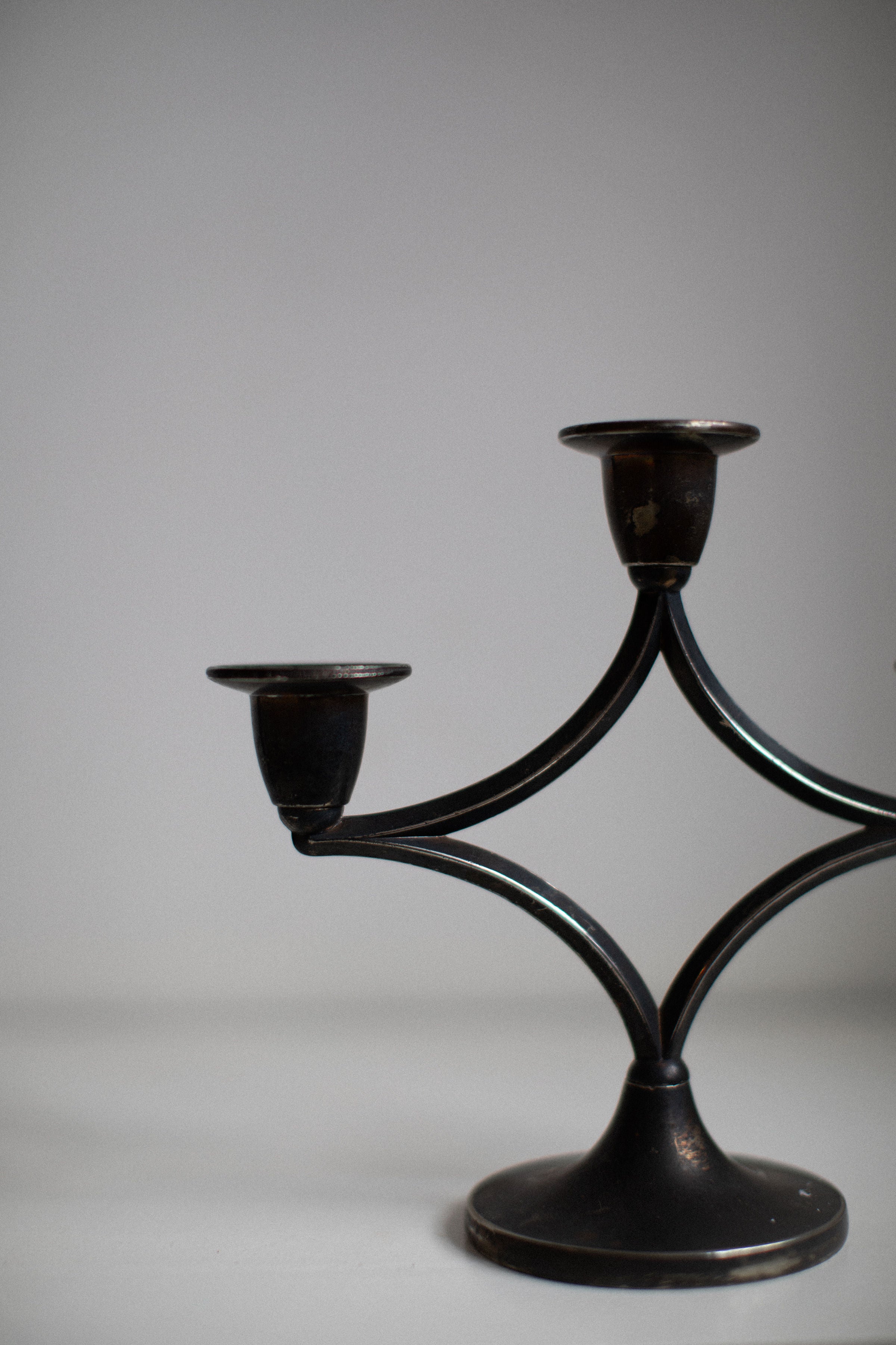 Dark silverplated candleholder featuring intricate detailing and elegant design for home decor