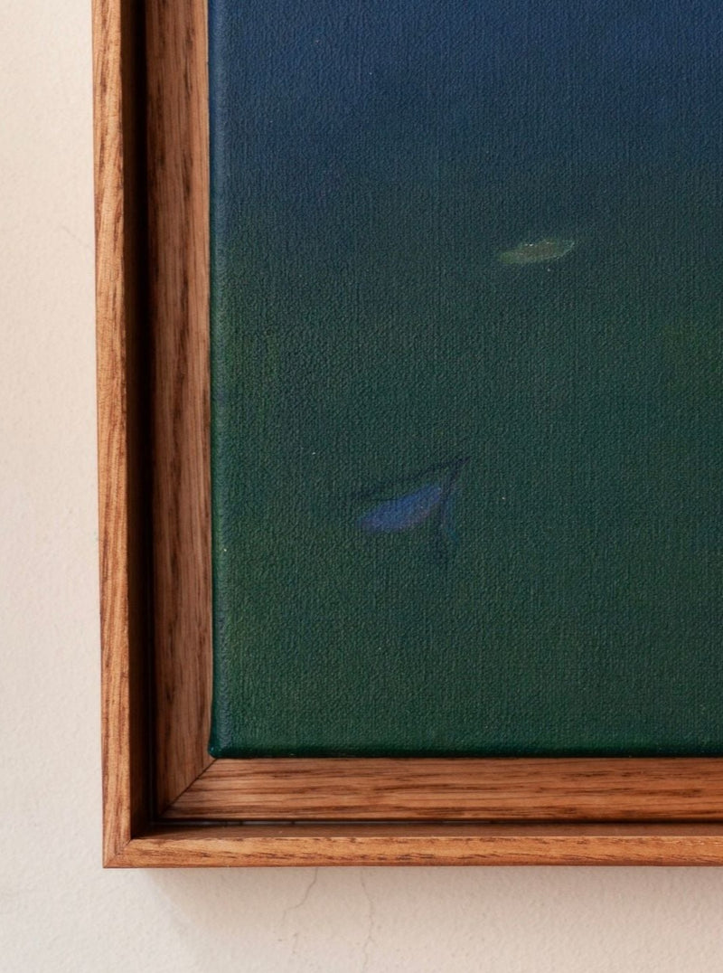 Close-up of a Ponds and Breezes #5, 2023 by Rebecca von Matérn, showing a section with a dark green background and a blurred blue brushstroke. The wooden frame has a light brown tone.