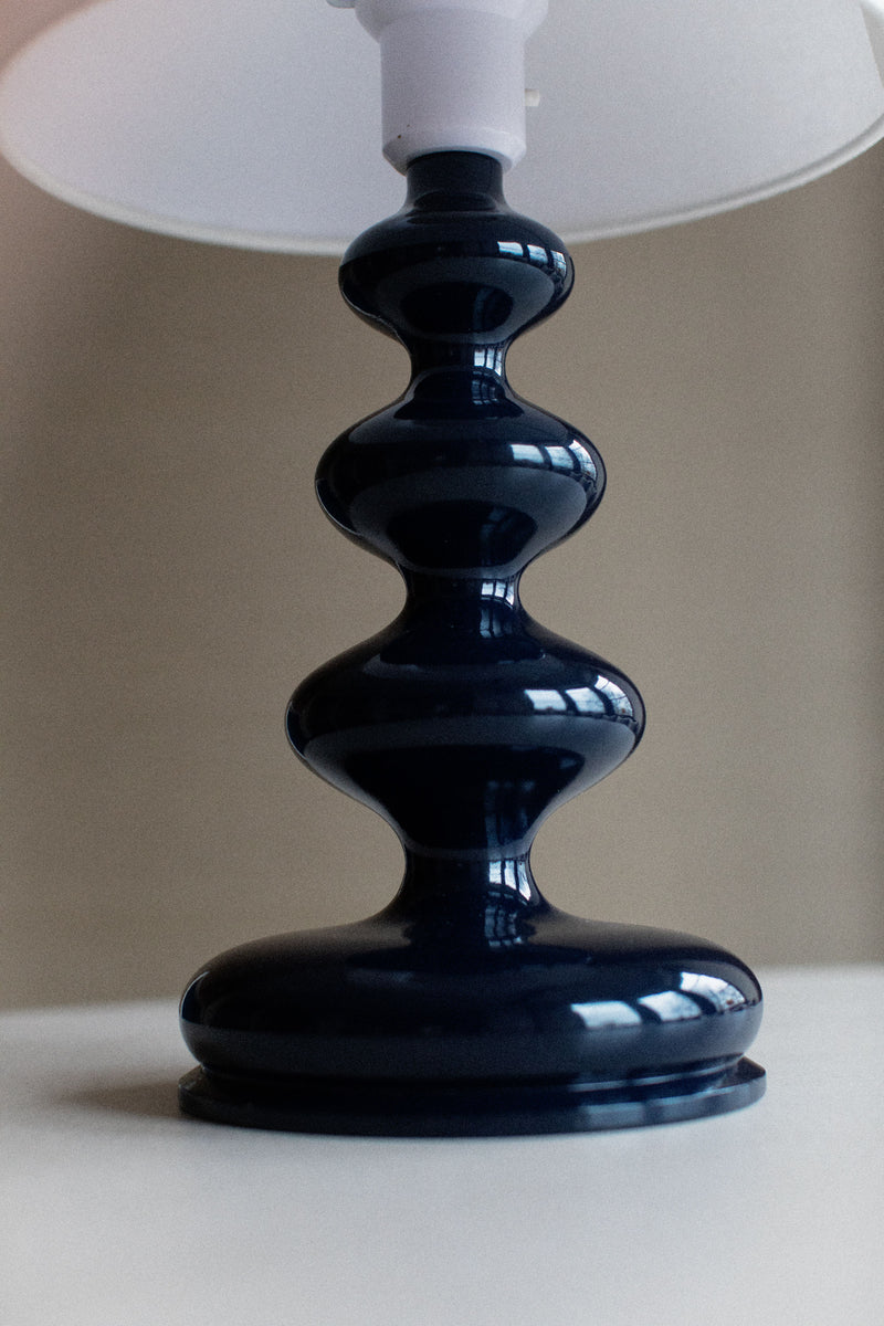 Modern sculptural lamp with sleek metal curves and black shade