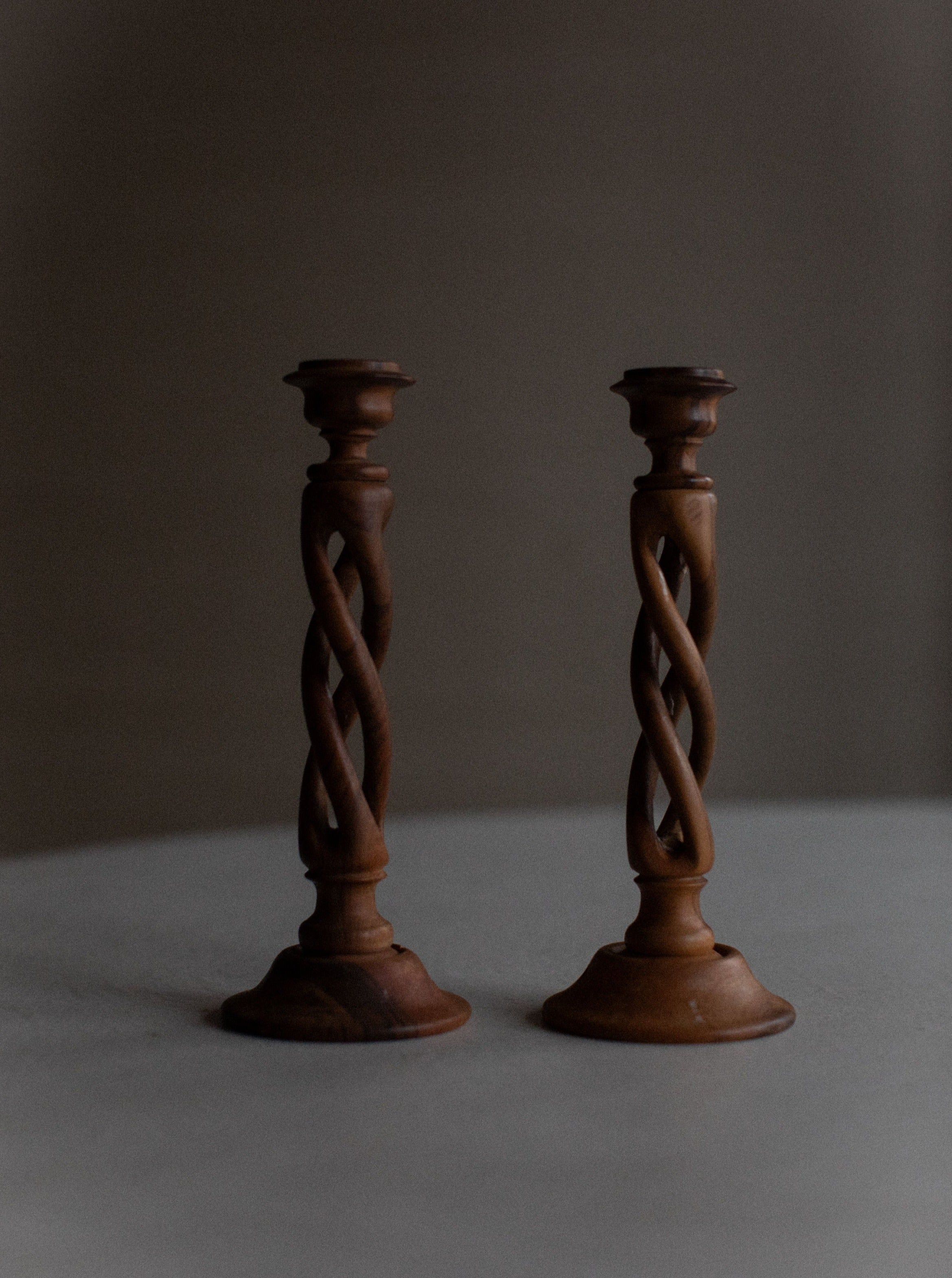 Handcrafted wooden candleholder with intricate carved details and rustic finish