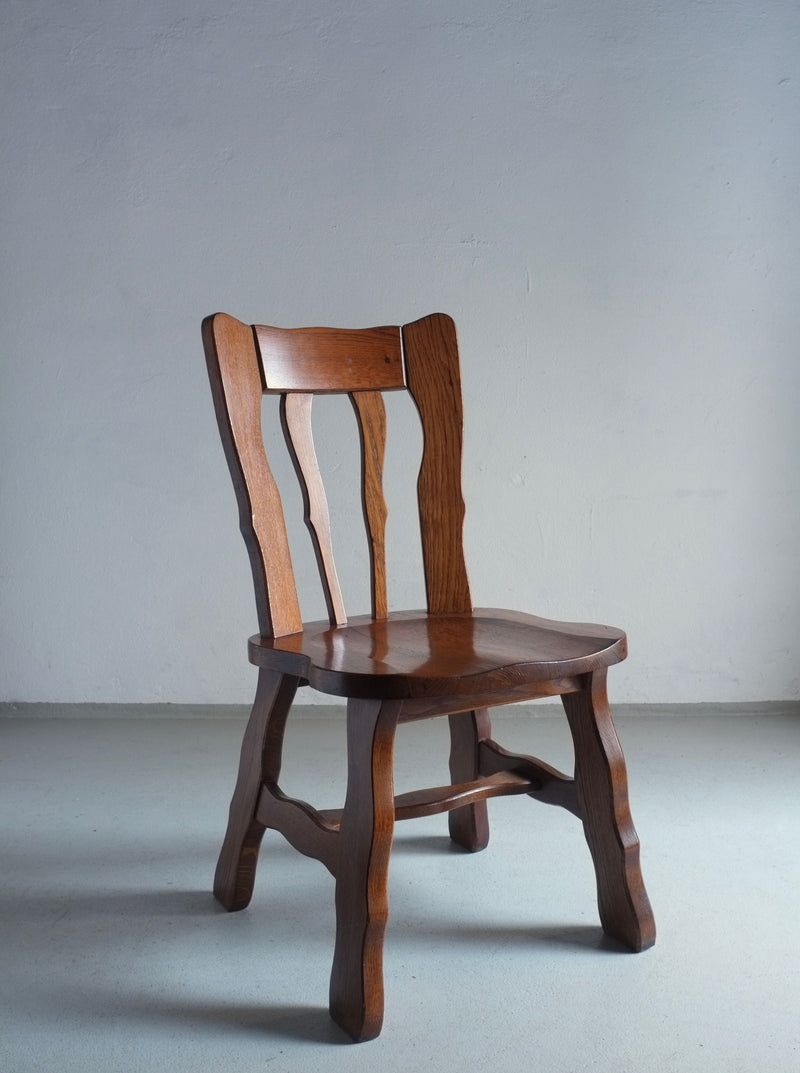 Pair of vintage Brutalist style carved oak dining chairs from the 1970s