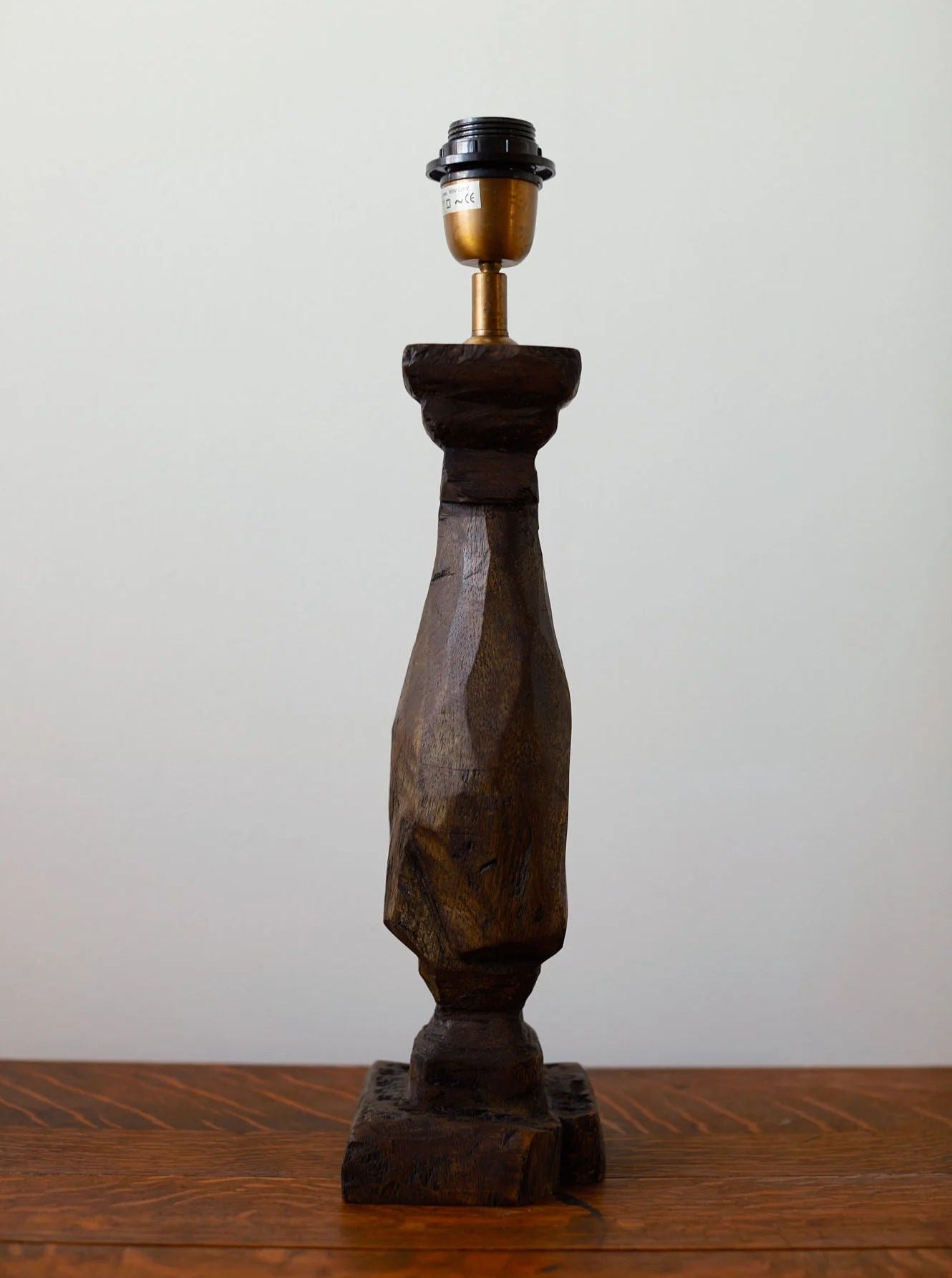 Artisanal standing lamp carved from natural wood with ornate details