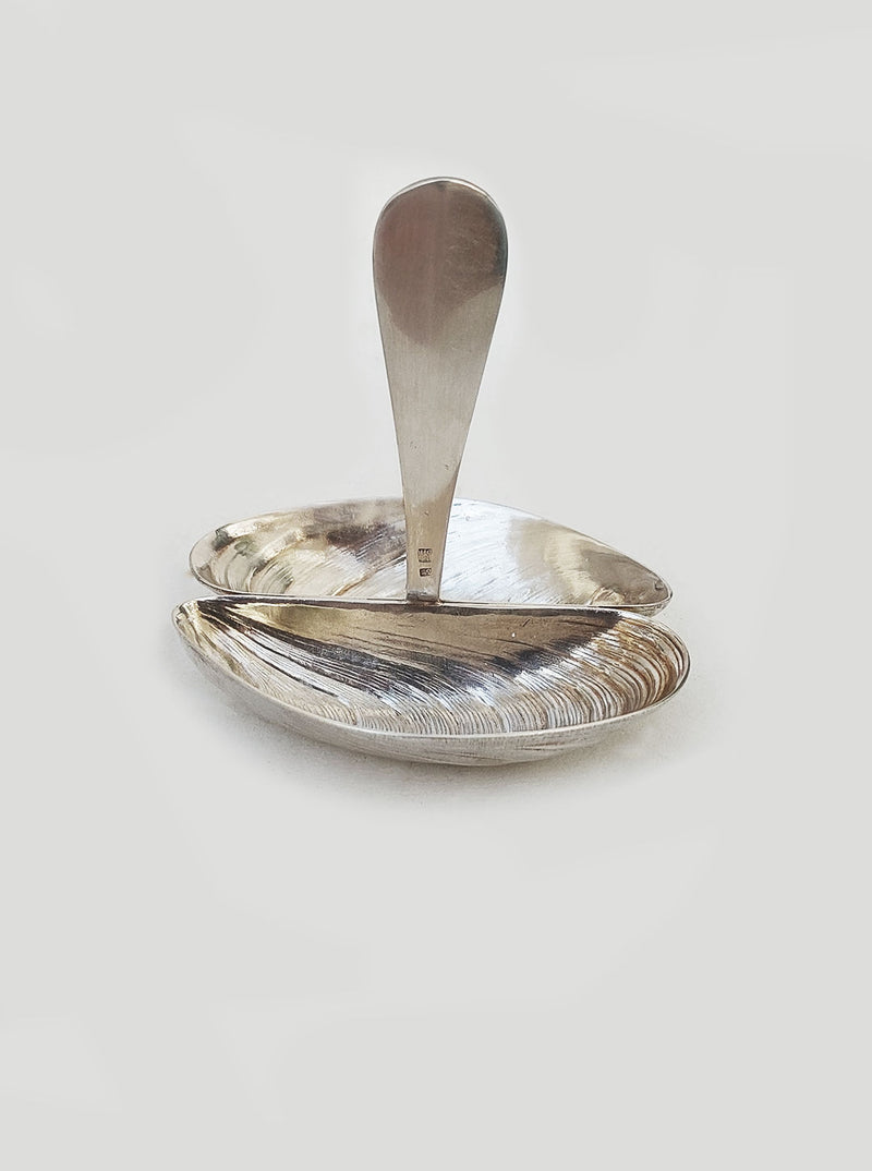 Shell shaped ceramic salt and pepper shakers on a white background