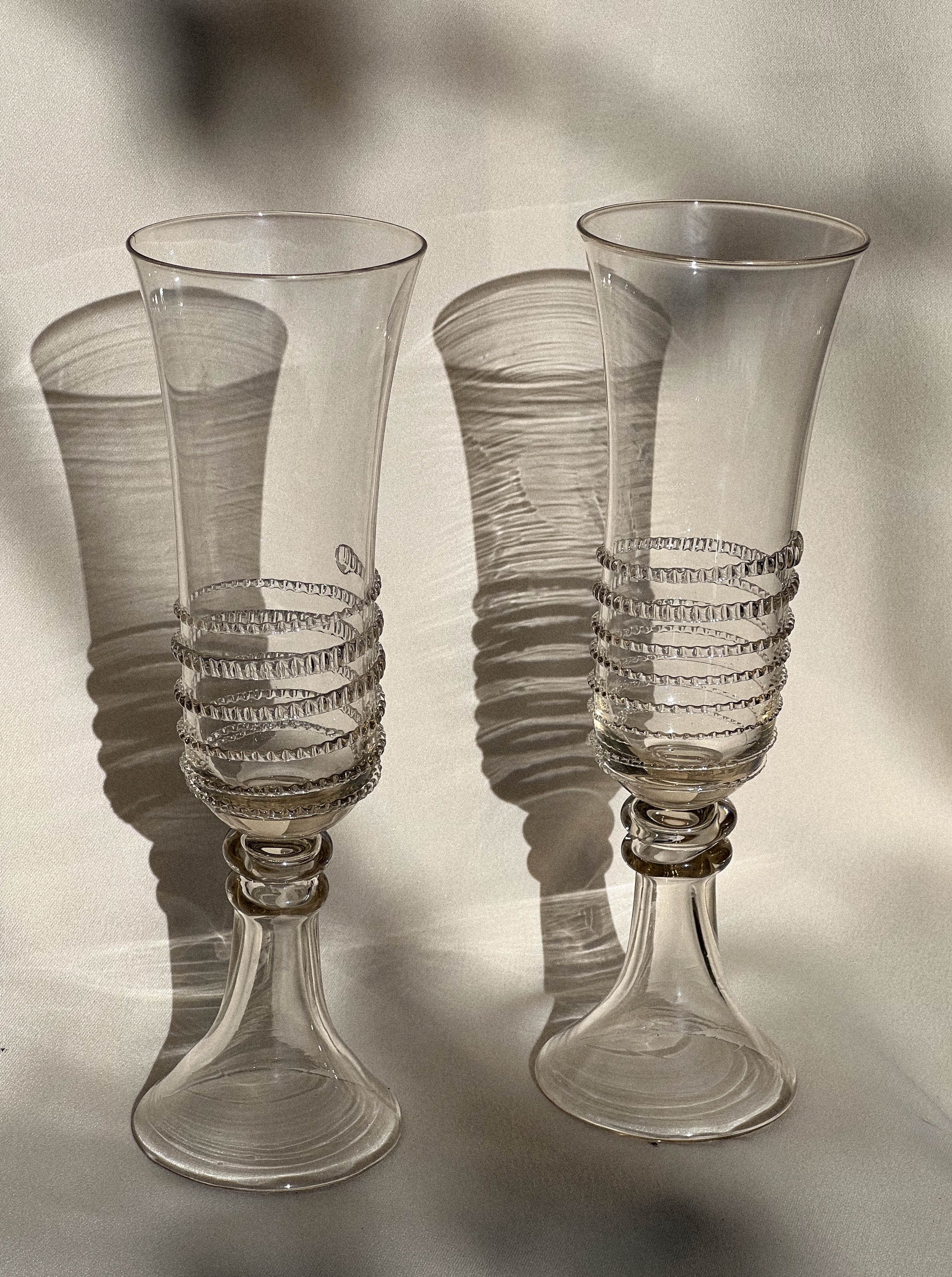 Pair of elegant mouthblown champagne flutes featuring beautiful spiral designs