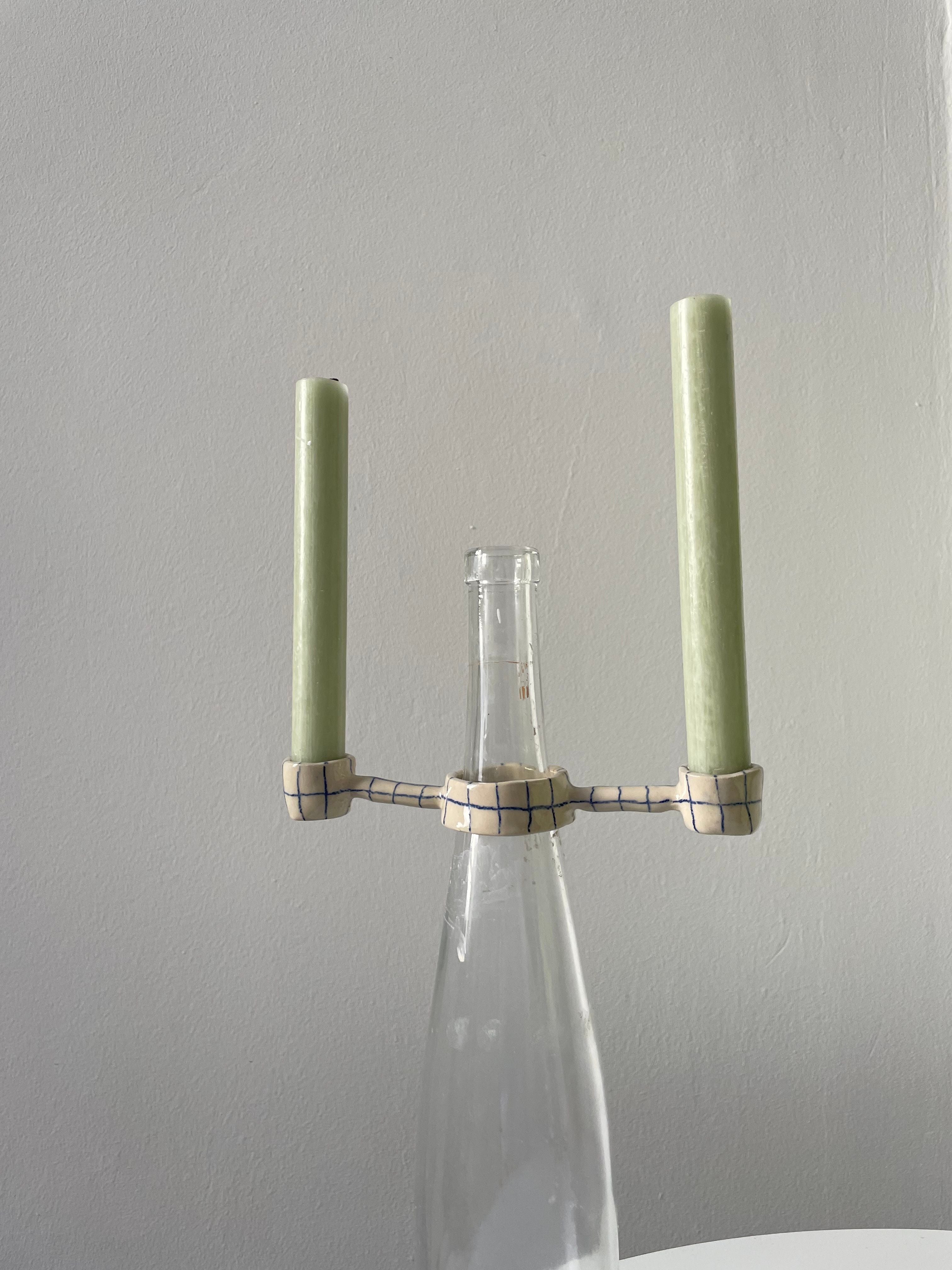 Beautiful and elegant Odette candle holder with intricate design and metallic finish