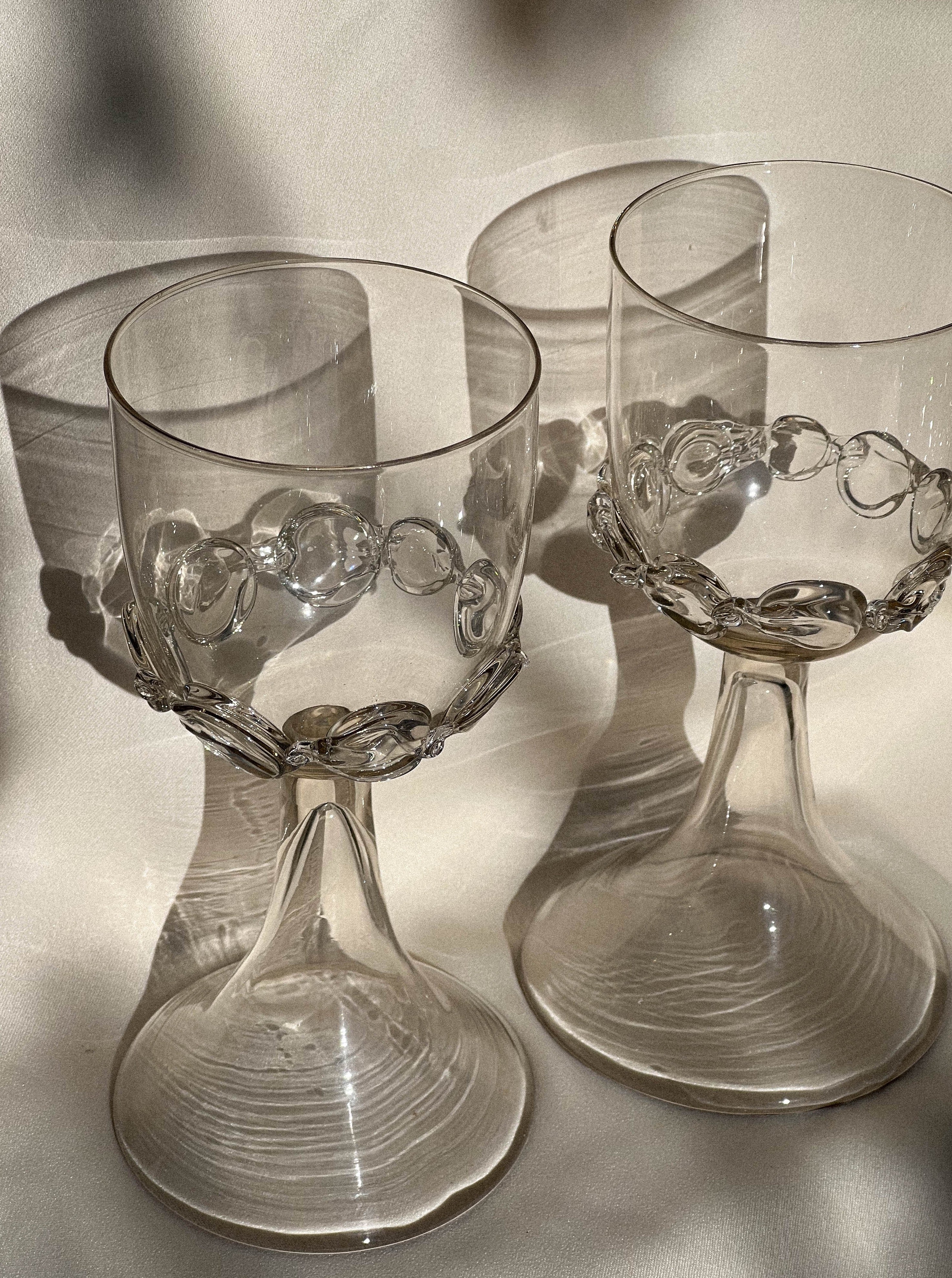 Elegant wine goblets featuring handblown glass and chain motif