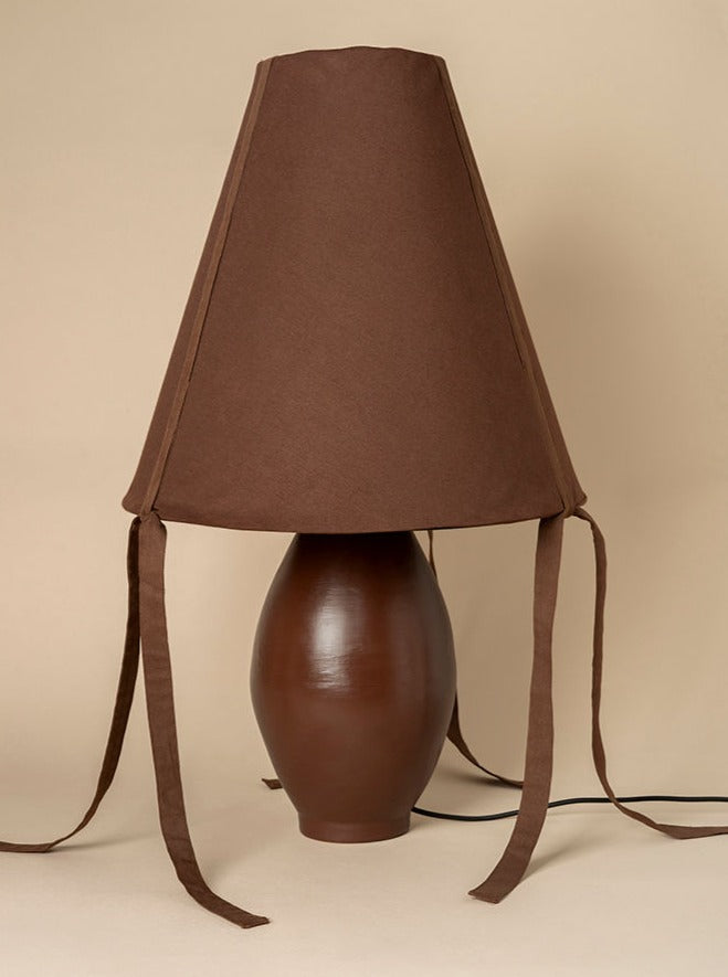 Beautiful-brown-ceramic-large-lamp-illuminating-cozy-corner