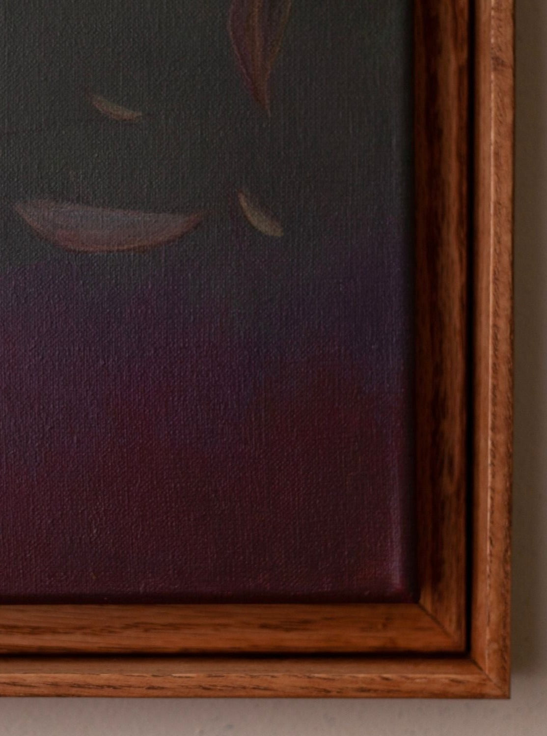 Close-up of "Ponds and Breezes #8, 2023" by Rebecca von Matérn, featuring a framed painting with abstract shapes in black, purple, and red hues. The smooth wooden frame enhances its minimalist aesthetic, casting a partial shadow over the artwork's sculptural feel.