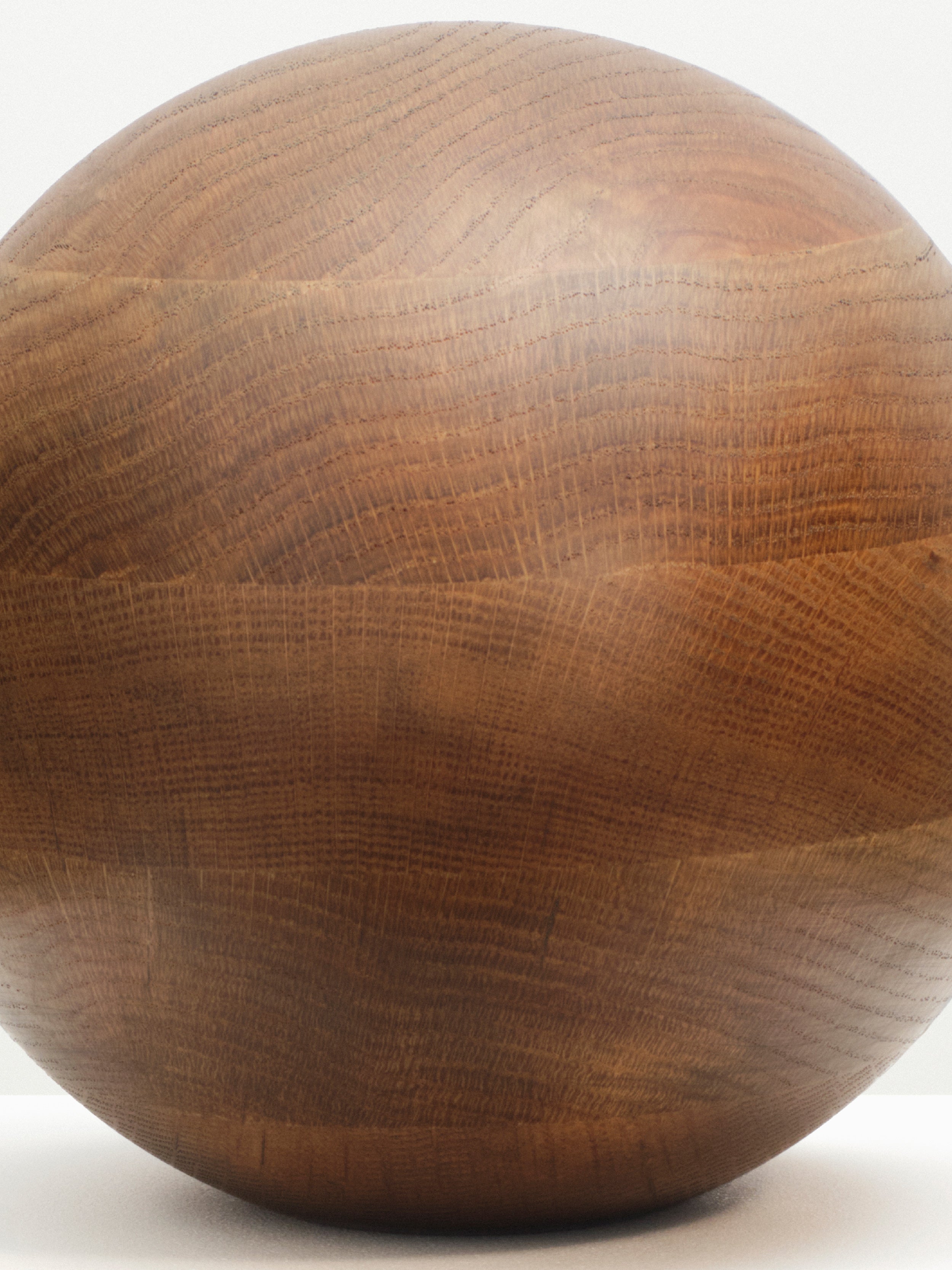  Smoked Oak Egg Sculpture displayed on a black background, casting a dramatic shadow