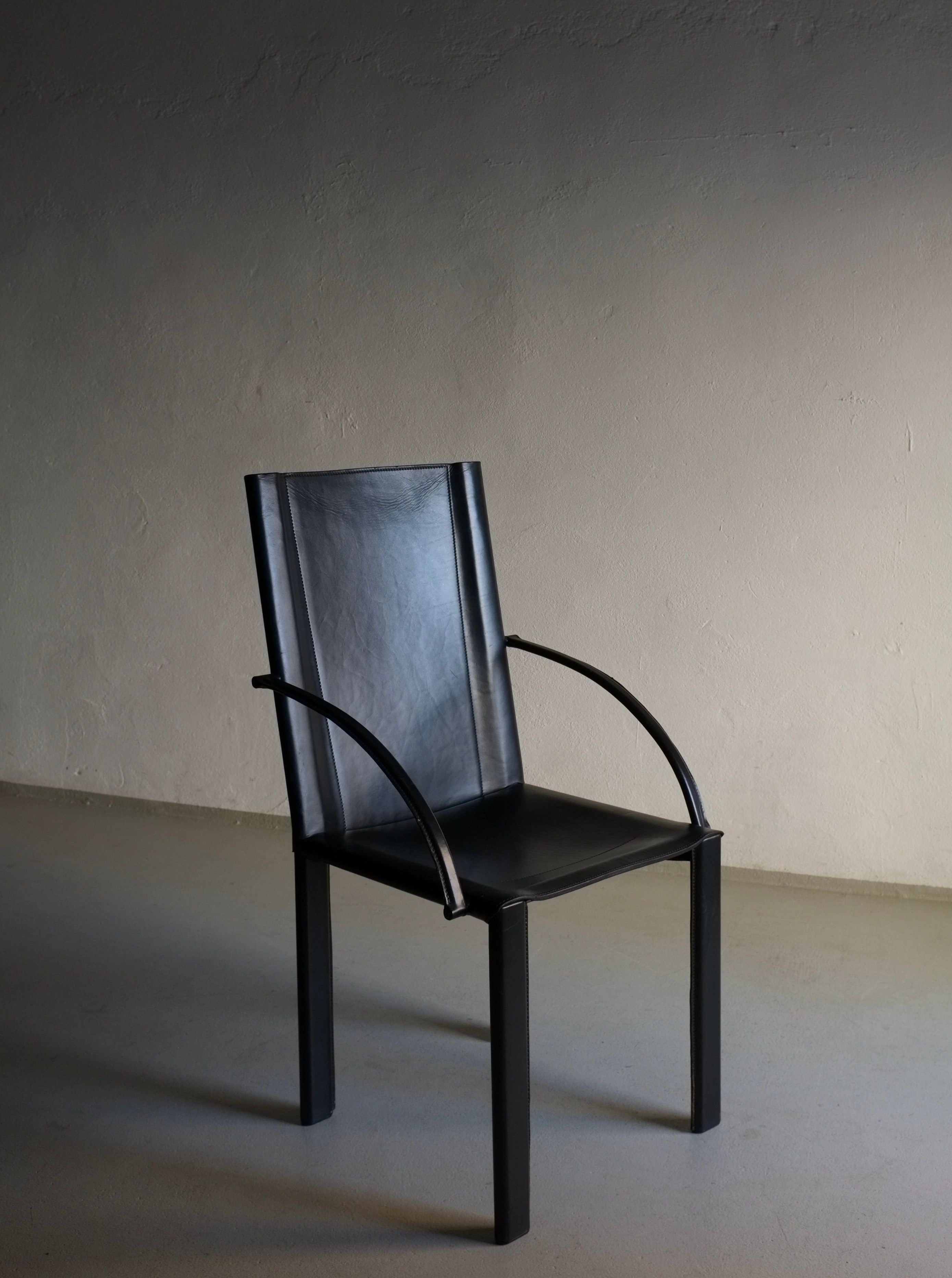 Postmodern chair with sleek chrome frame and black leather seat