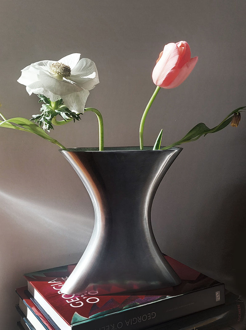 Two elegant glass vases, one tall and slender, the other short and round, both featuring a unique tam tam pattern, perfect for displaying flowers or standing alone as decorative pieces