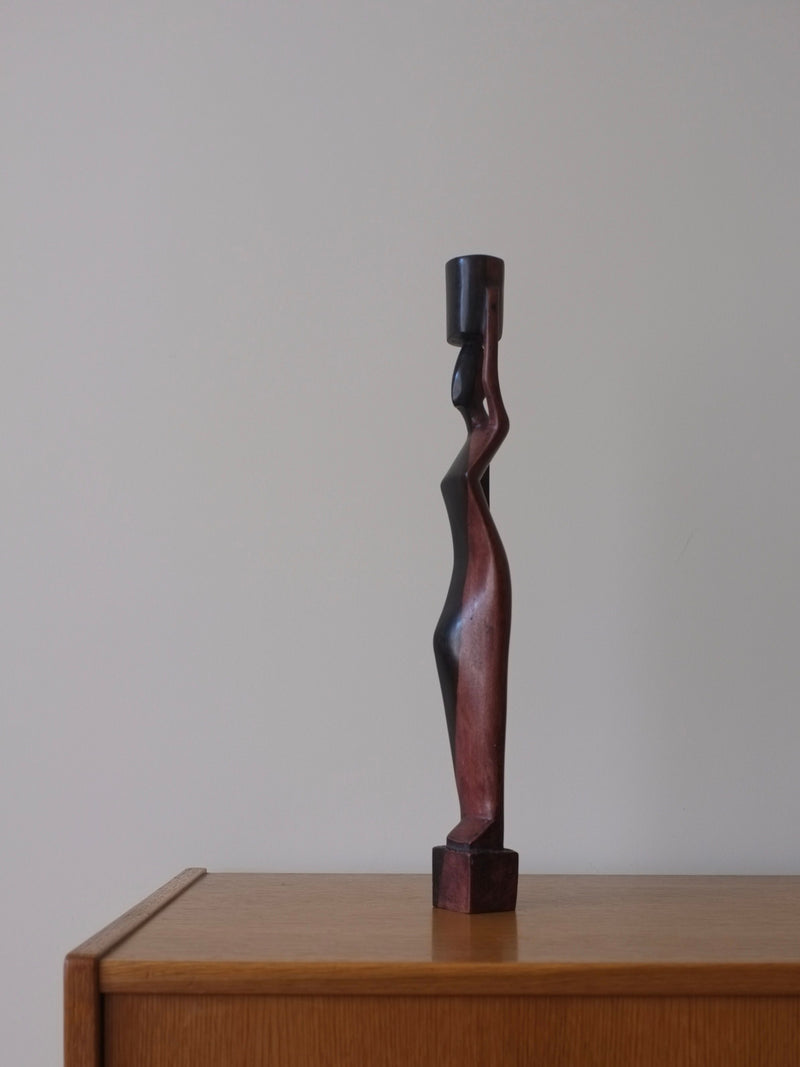 Hand-carved-wood-candleholder-depicting-a-female-figure-with-flowing-robes