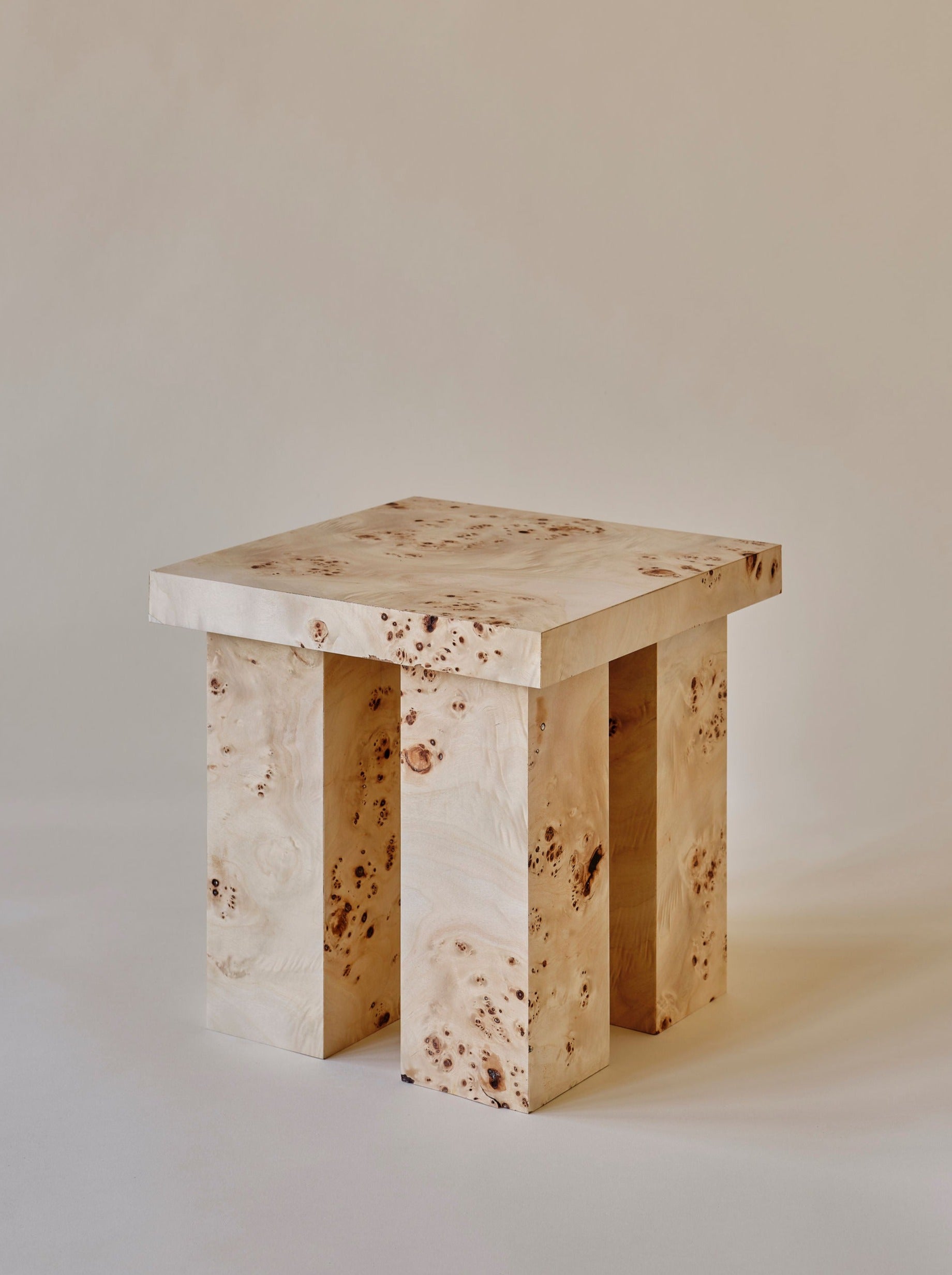 A modern, wooden Miter side table with a sleek, angular design