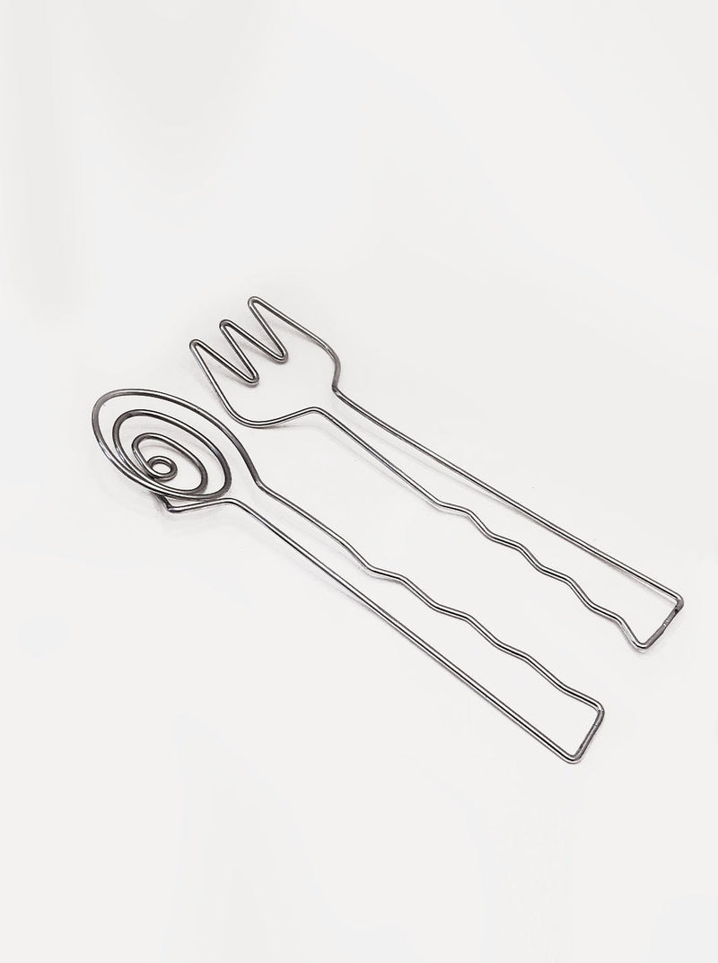Stylish stainless steel salad servers with wooden handles for serving greens and vegetables at dinner parties or everyday meals