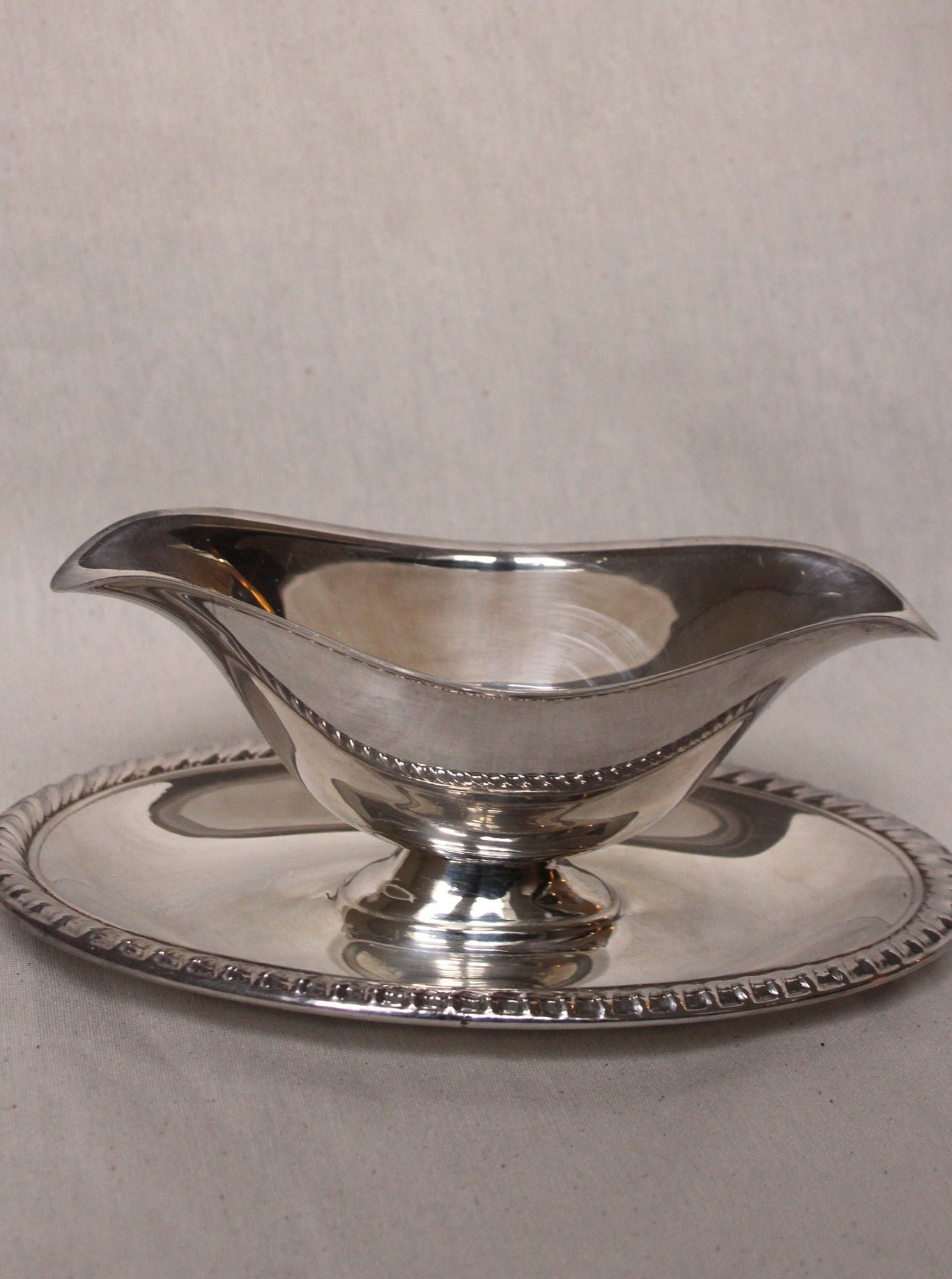 Gravy boat featuring a smooth and polished finish for serving sauces