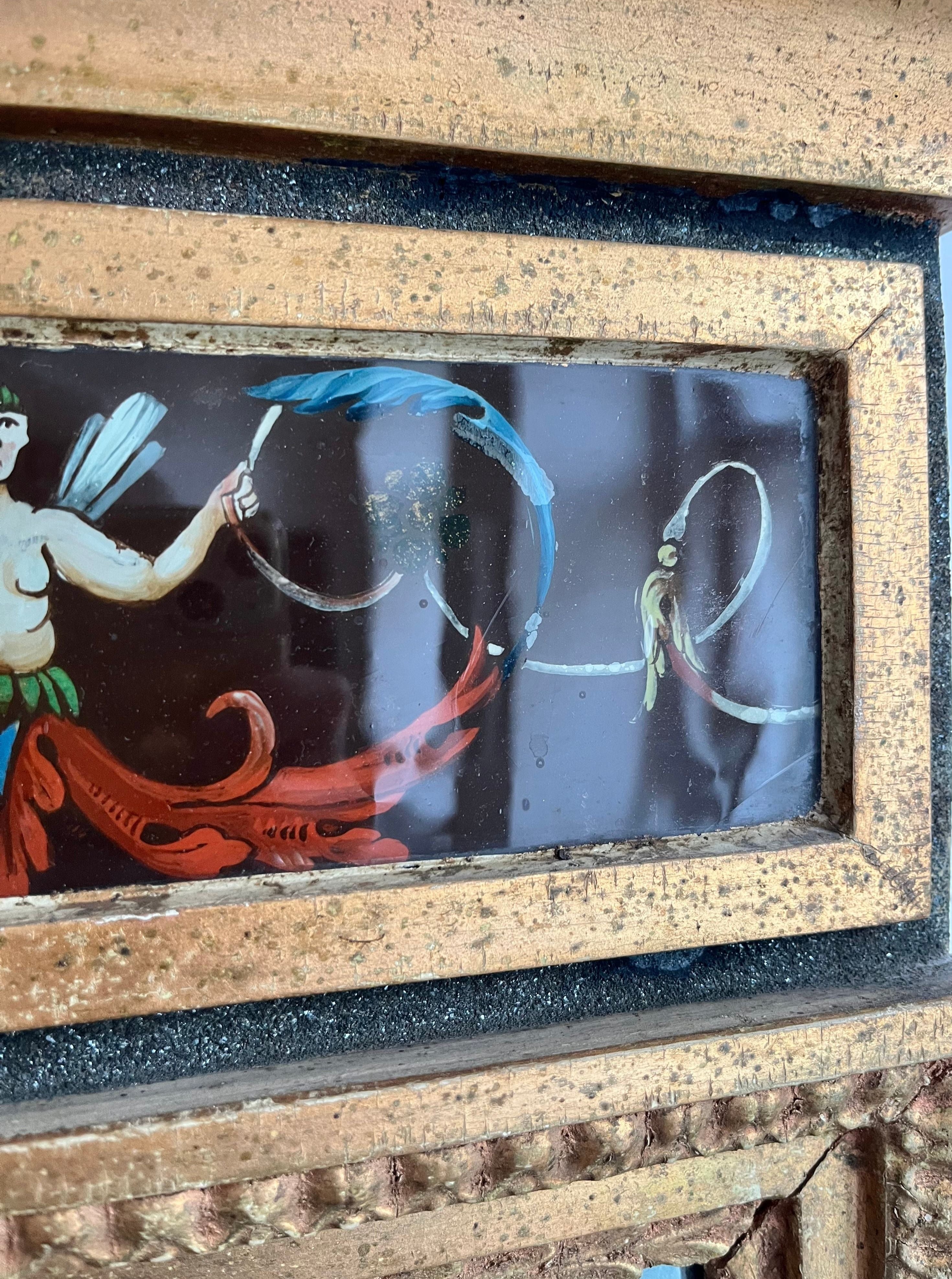 Antique framed art depicting two women in flowing red dresses, each holding a blue hoop, set against a blue background, enclosed in a Médecine Antique Gilded Mirror.