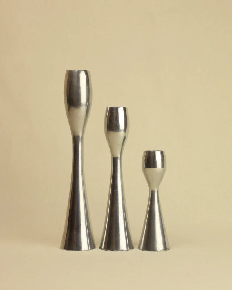Set of three minimalist candleholders in black, gold, and silver
