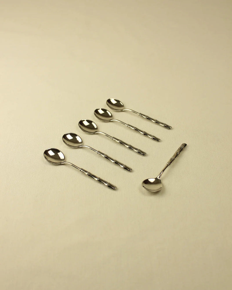 Six Bamboo Silver-Plated Spoons with ornate handles are orderly arranged on a light beige surface, diagonally positioned from the top left to the bottom right. (Boga Avante Shop)