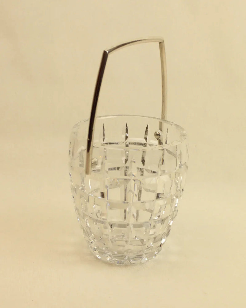 Indulge in luxury with the Crystal Cubitera from Boga Avante Shop, featuring a stunning geometric pattern in clear faceted glass and a sleek silver-tone metal handle, all set against a plain light background.