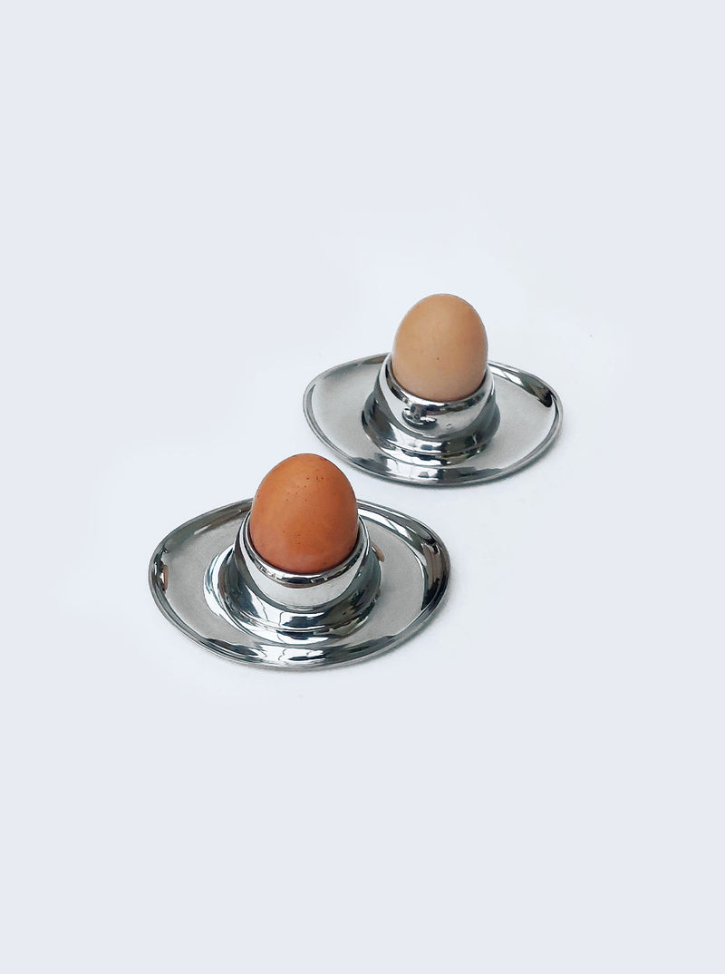 Set of 4 white ceramic egg cups with colorful geometric designs