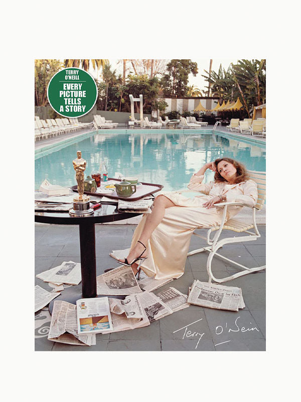 A woman in a silk robe reclines on a lounge chair by a pool scattered with newspapers, a small Oscar statuette on the table, and a backdrop of palm trees reminiscent of the Maison Plage Hollywoodland Stack - set of 3.