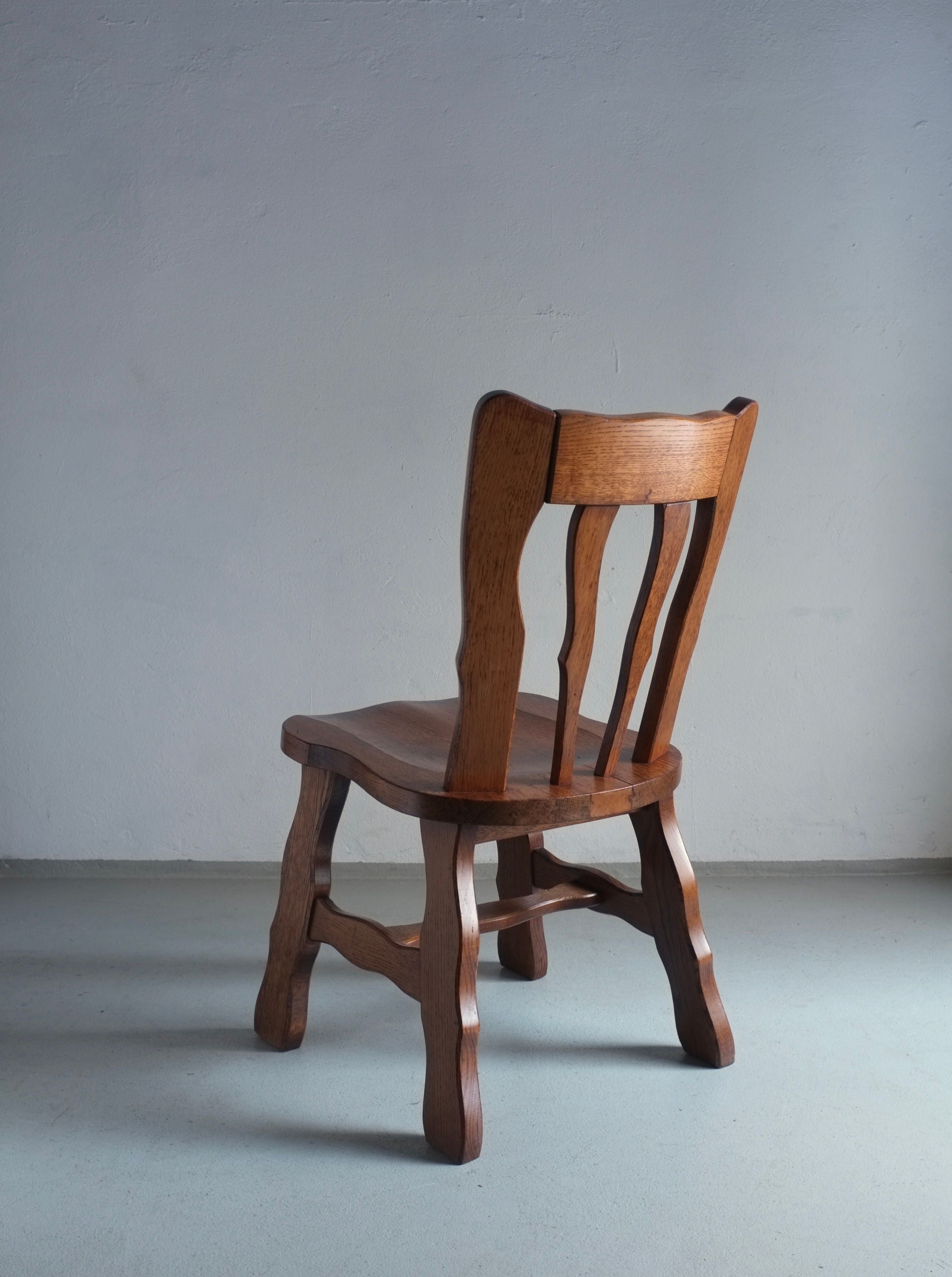 Pair of vintage 1970s Brutalist style oak dining chairs with carved detailing