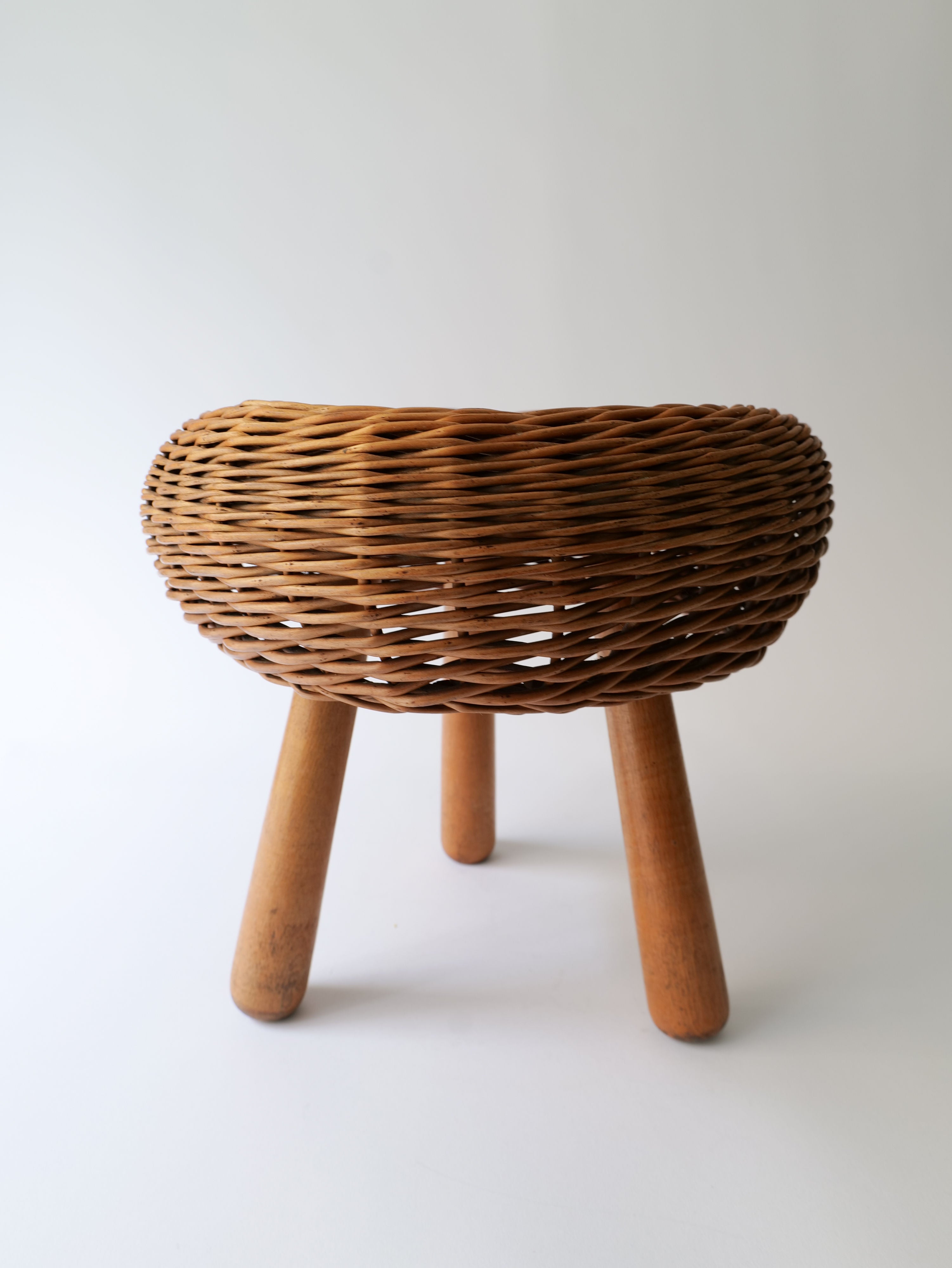 Hand-woven rattan stool with a sleek and modern design by Tony Paul