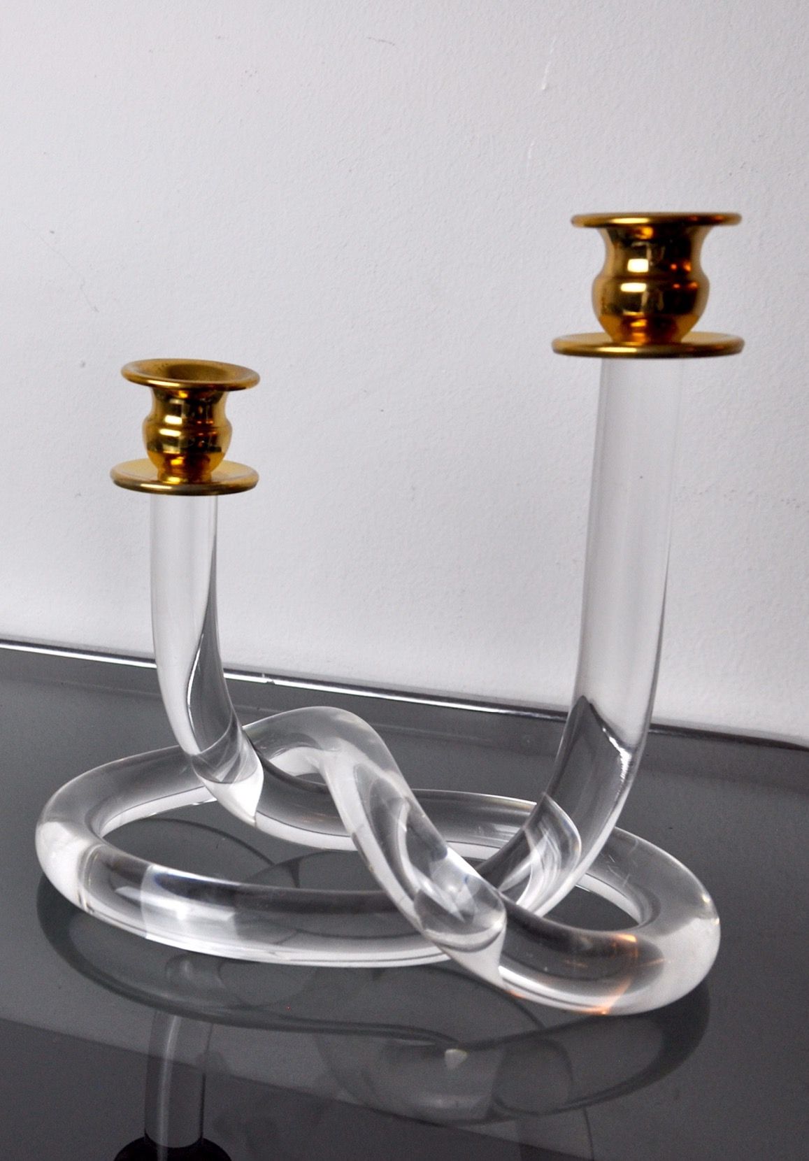  Pair of 1970 Dorothy Thorpe Pretzel Methacrylate Candle Holders, made of clear lucite with a twisted pretzel design, a stunning addition to any retro or mid-century modern home decor