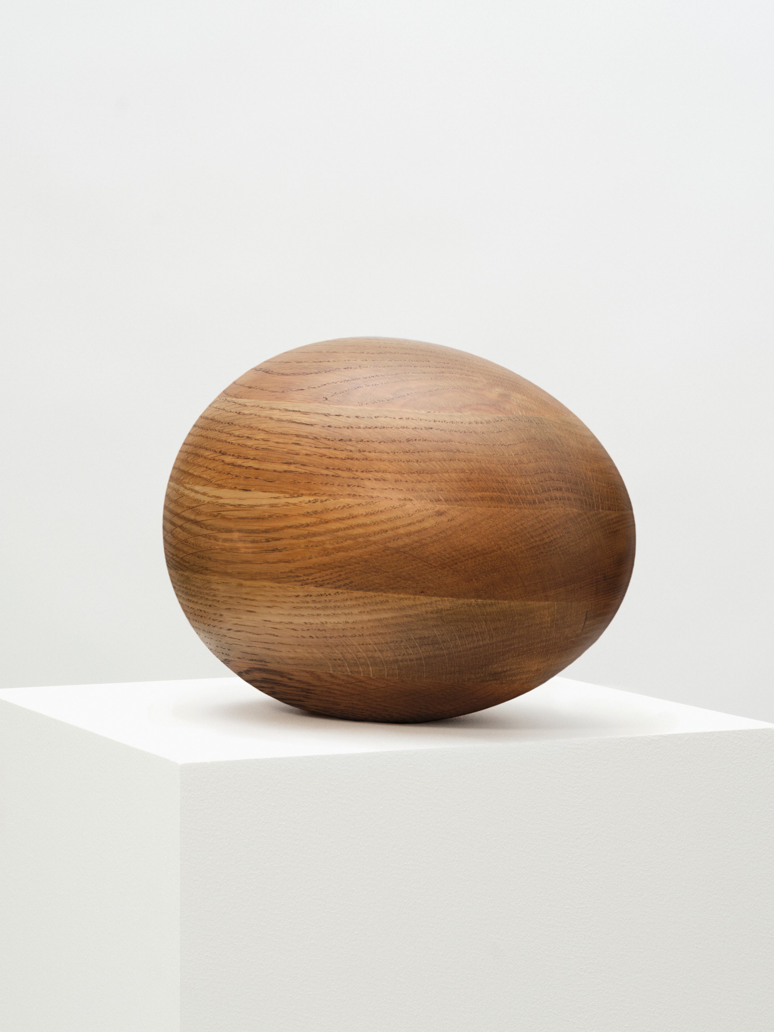 Close-up of Smoked Oak Egg Sculpture, highlighting the natural grain and rich color variations