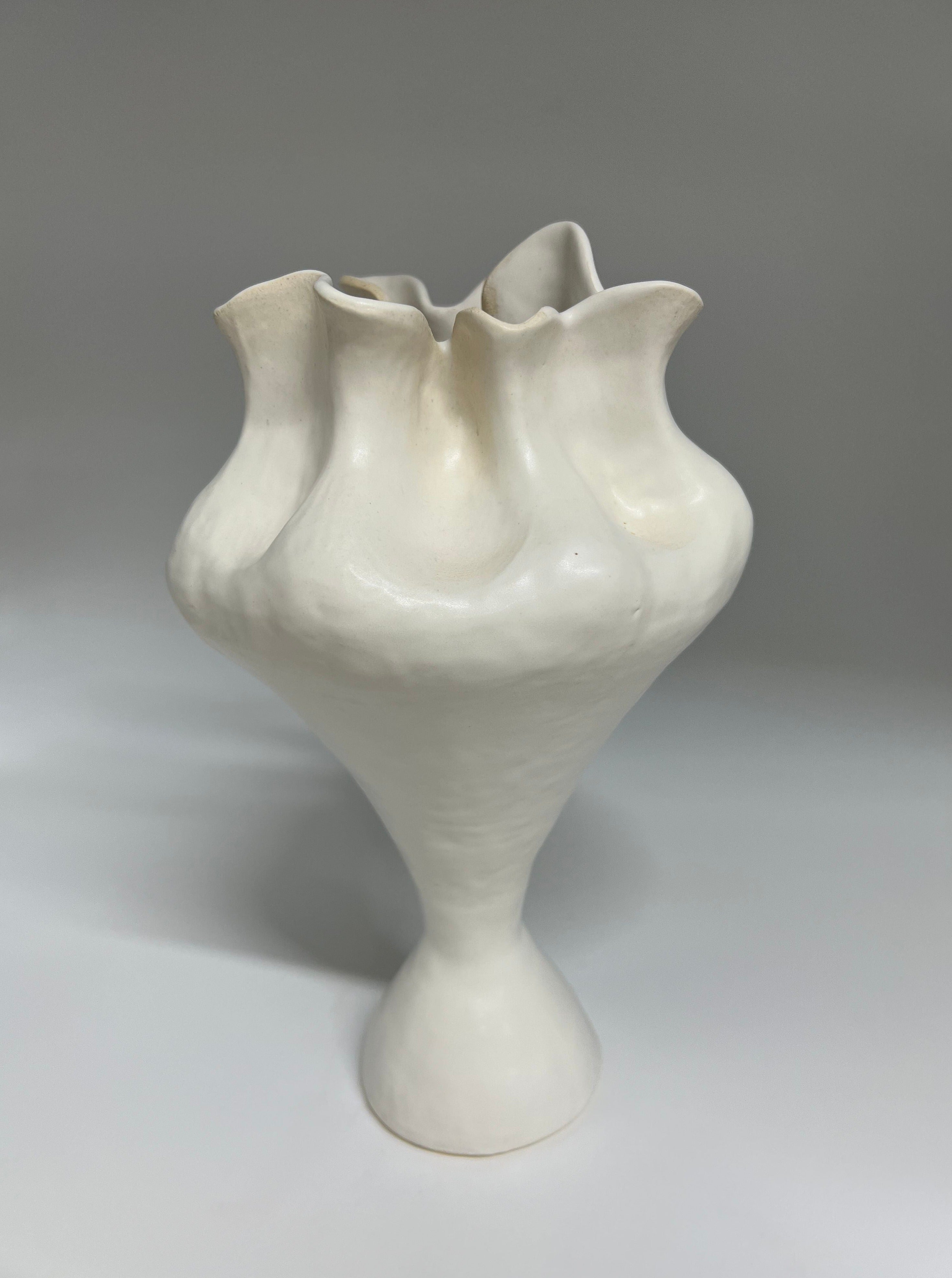 Modern sculptural vase with a tall, slender silhouette and matte glaze finish