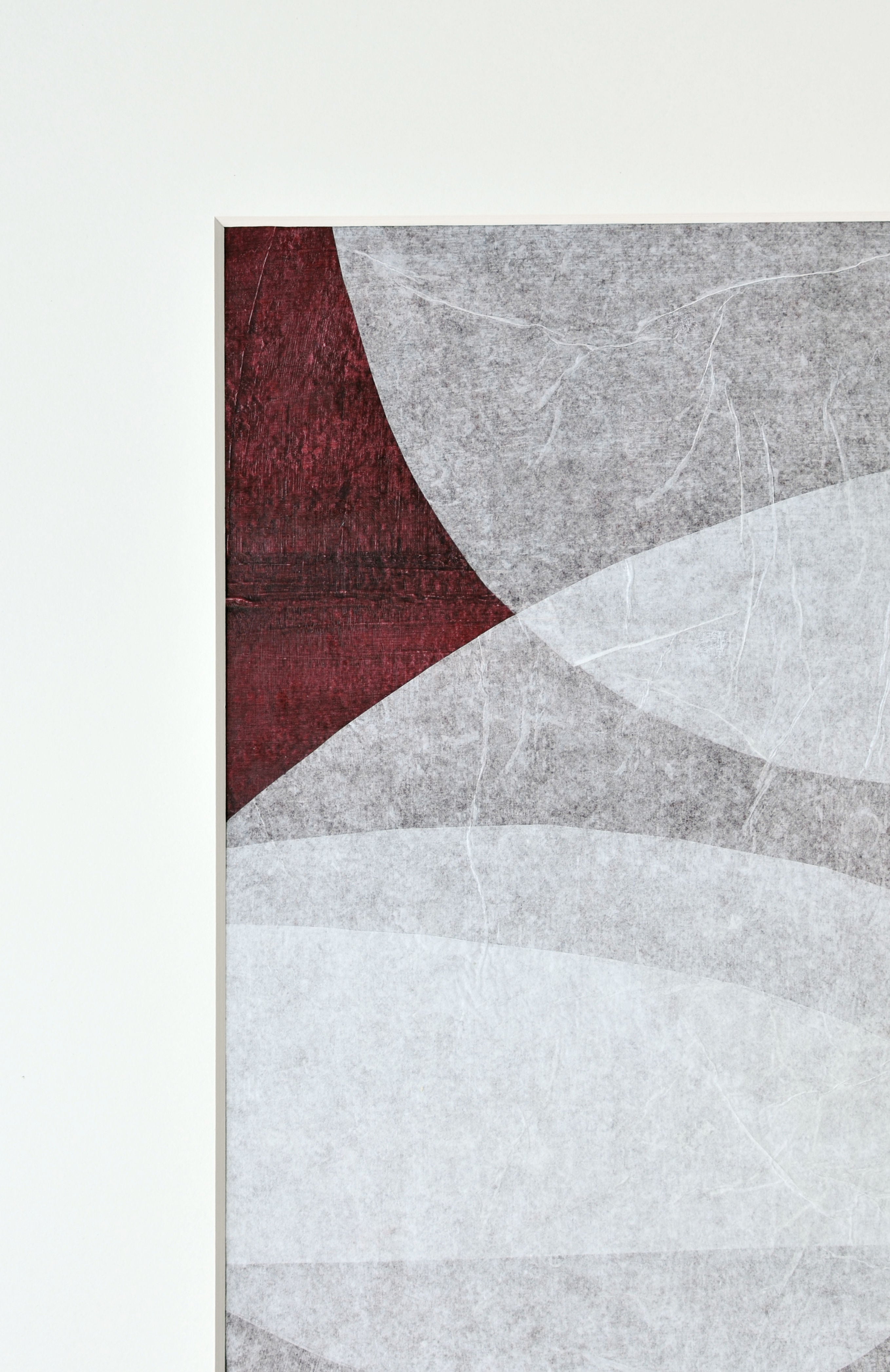 Abstract art piece featuring curved lines in grey tones with a textured deep red segment on handmade cotton paper by Julita Elbe's Moment.