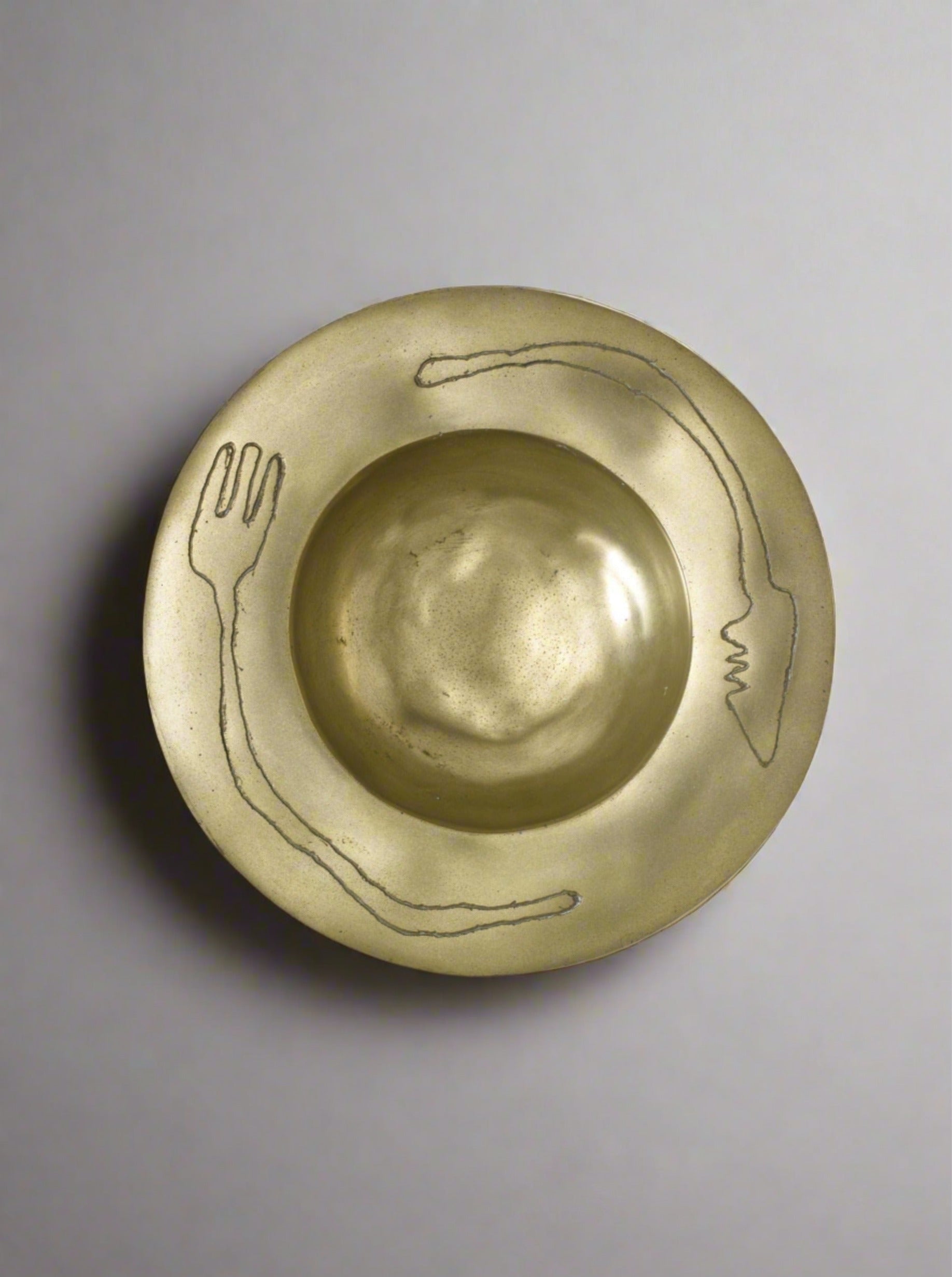 Knife and fork brass sculpture bowl with intricate detailing and polished finish