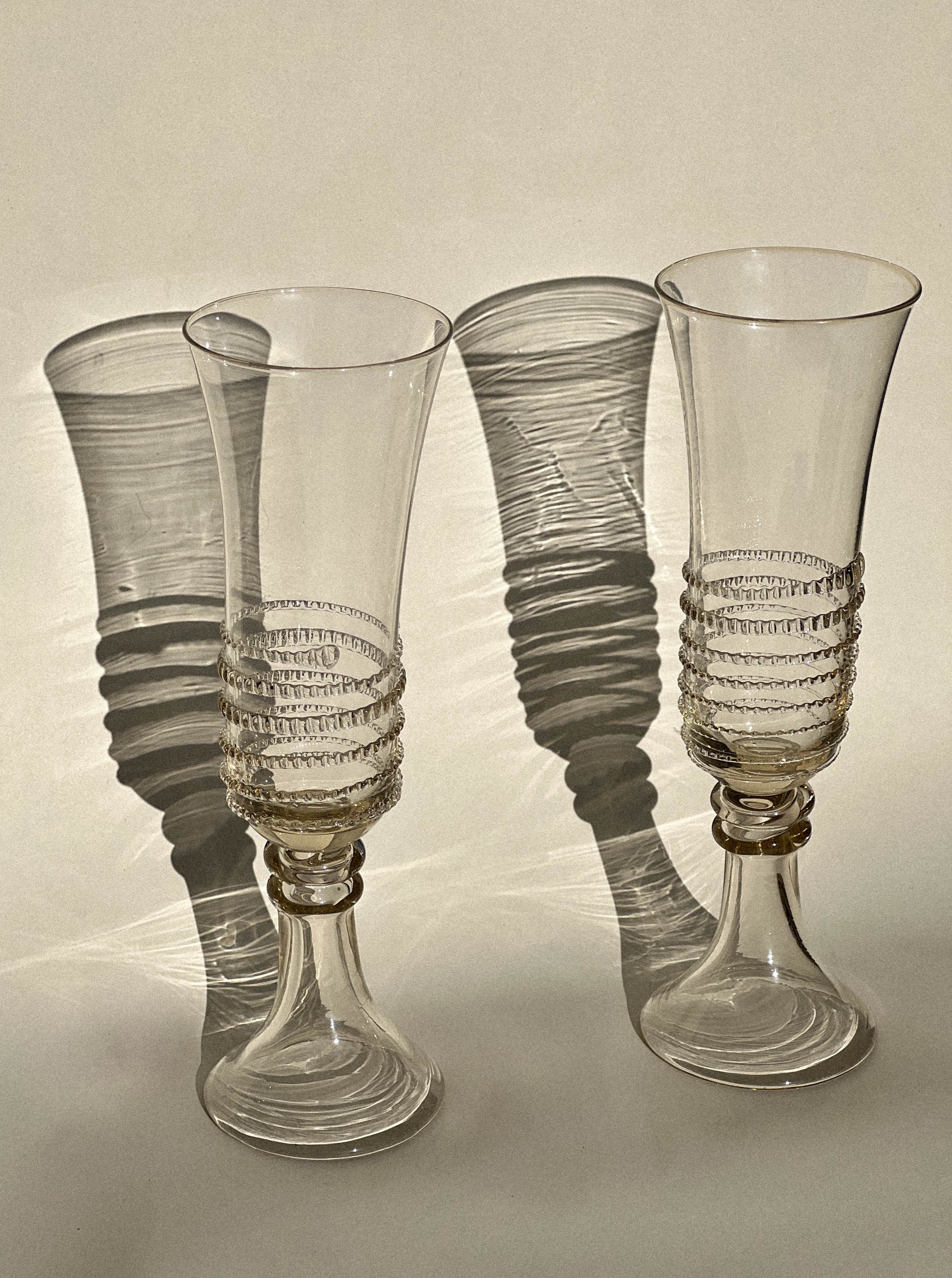 Artisanal mouthblown champagne flutes featuring mesmerizing spiral motifs