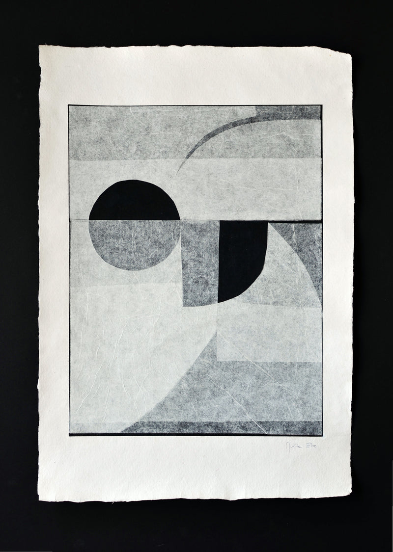 Abstract Invisible black and white print featuring geometric shapes with circular and curved forms overlaid on shaded squares, centered on textured handmade cotton paper, signed at the bottom right by Julita Elbe.