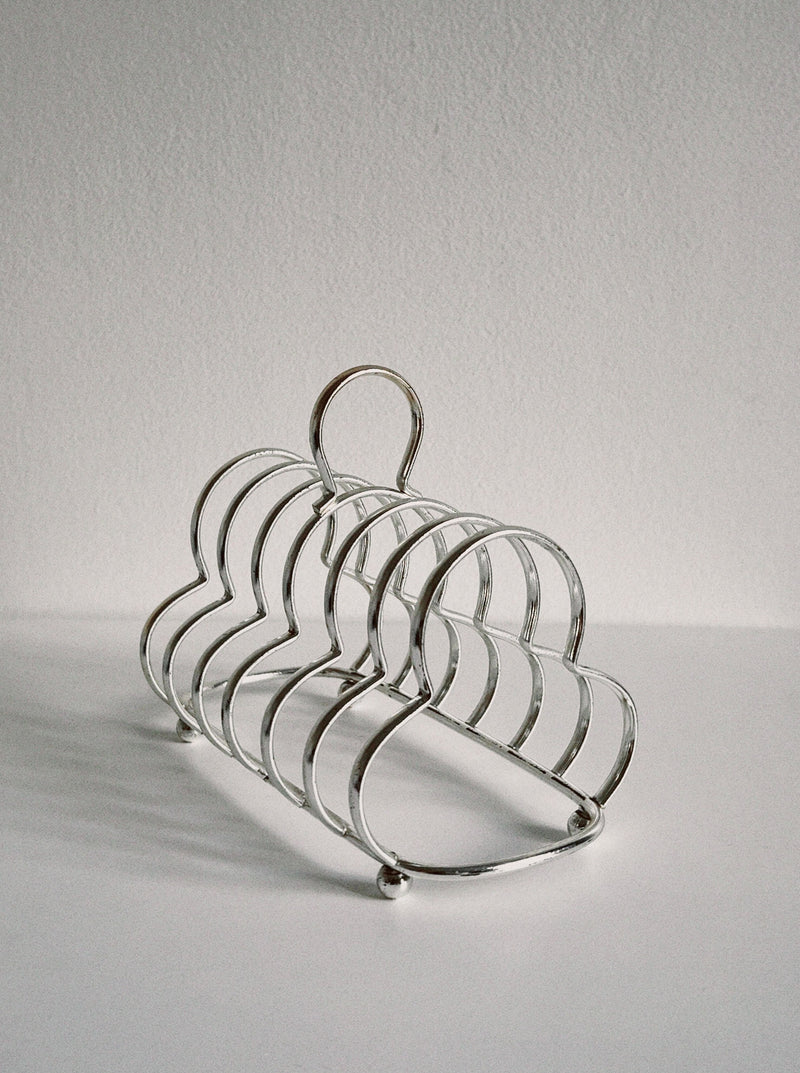 Club shaped toast holder made of stainless steel for serving breakfast