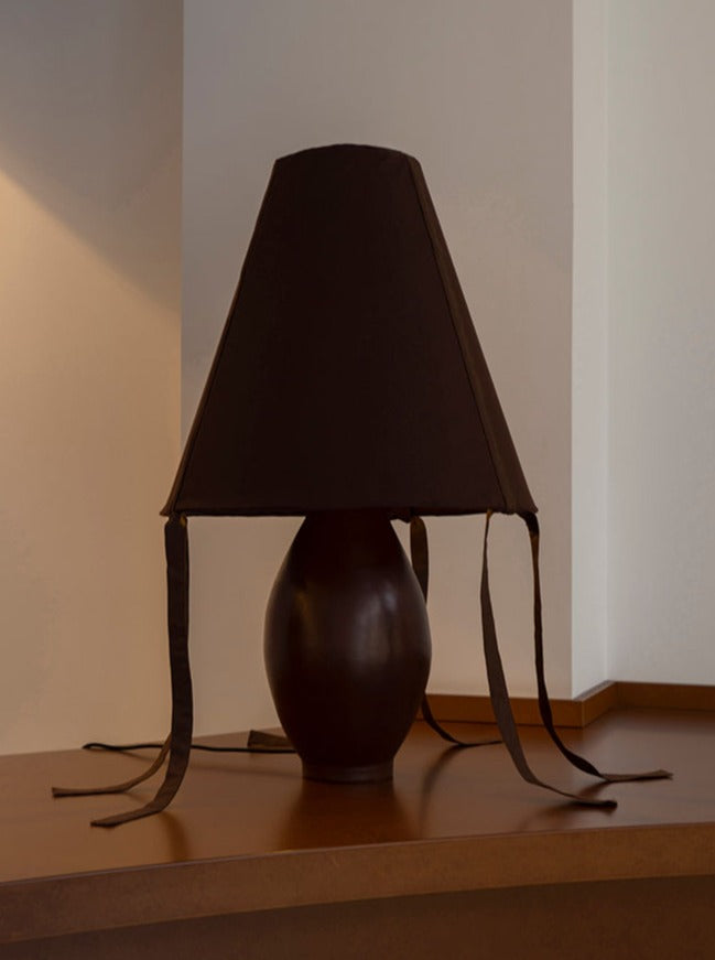 Close-up-of-brown-ceramic-large-lamp-with-detailed-texture