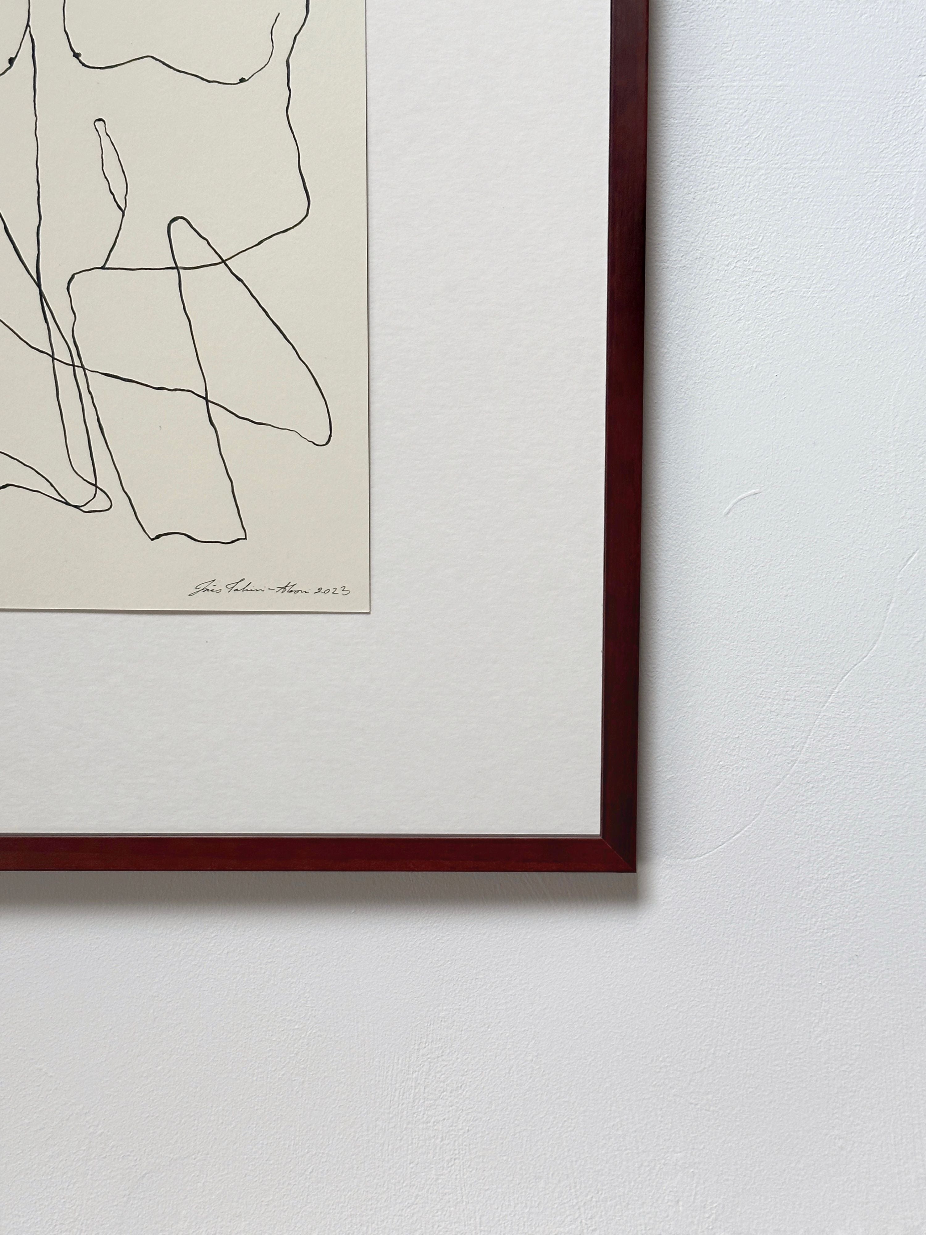 An abstract line drawing in a dark wooden frame, featuring minimalist black lines that intertwine to form a human silhouette on a cream background, signed by the artist at the bottom left. The artwork hangs on Tangled up 09 by Inès Tahiri-Alaoui.