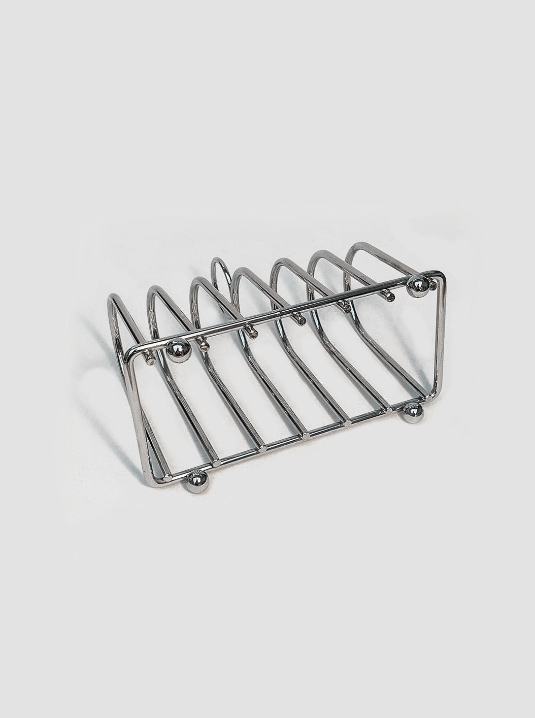 A modern stainless steel Art Deco Toast Rack from Les Objets with six slots, displayed on a plain white background.